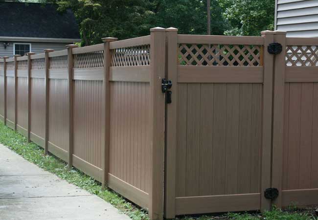 brown vinyl open top privacy fencing and gate